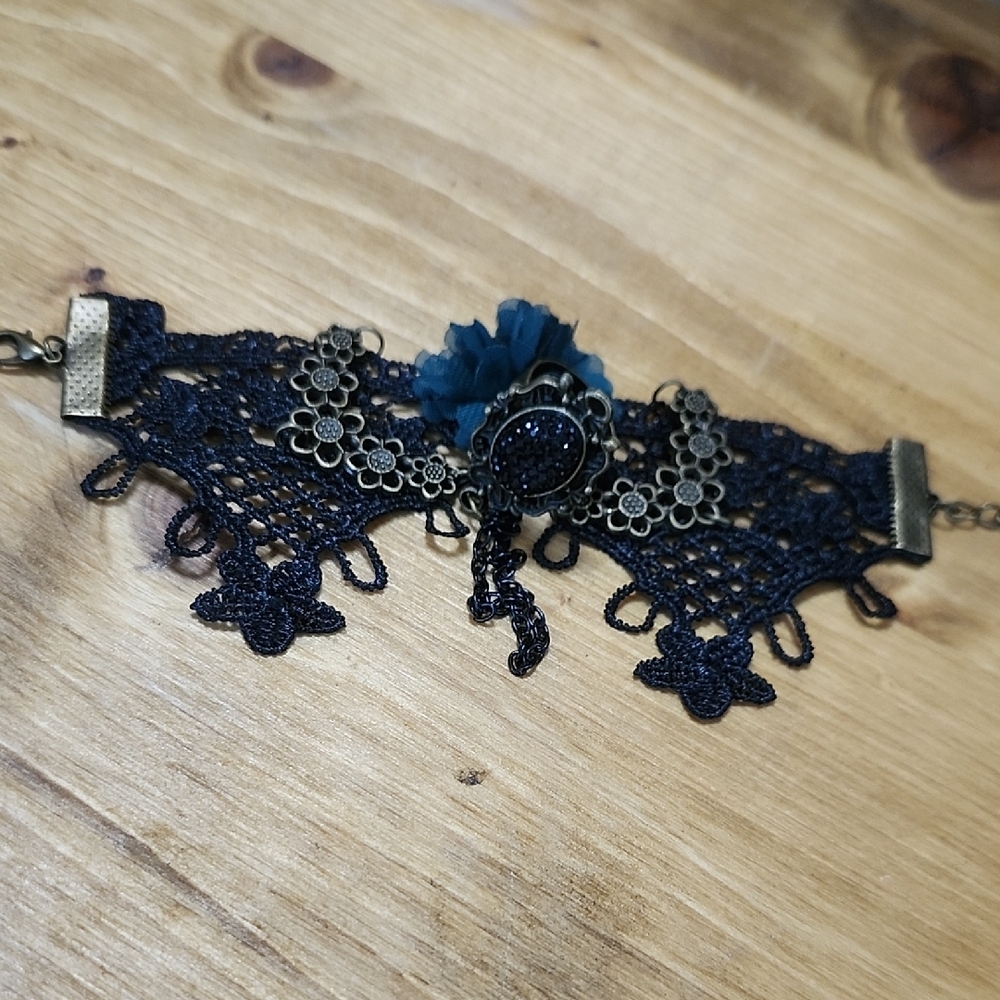 Black Lace Bracelet With Attached Ring And Blue Flower Accent